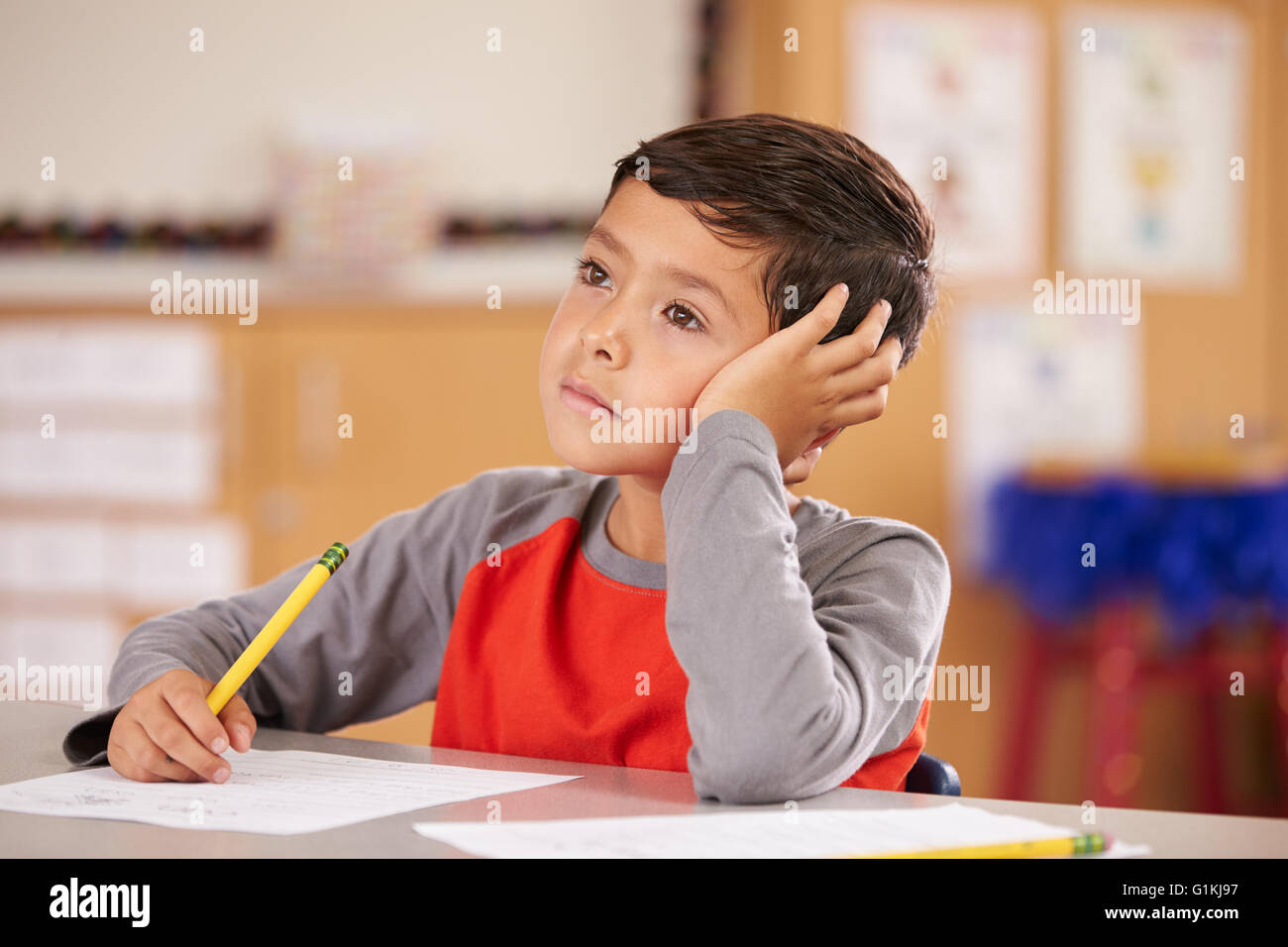 Portrait of a boy daydreaming in an elementary school class Stock Photo