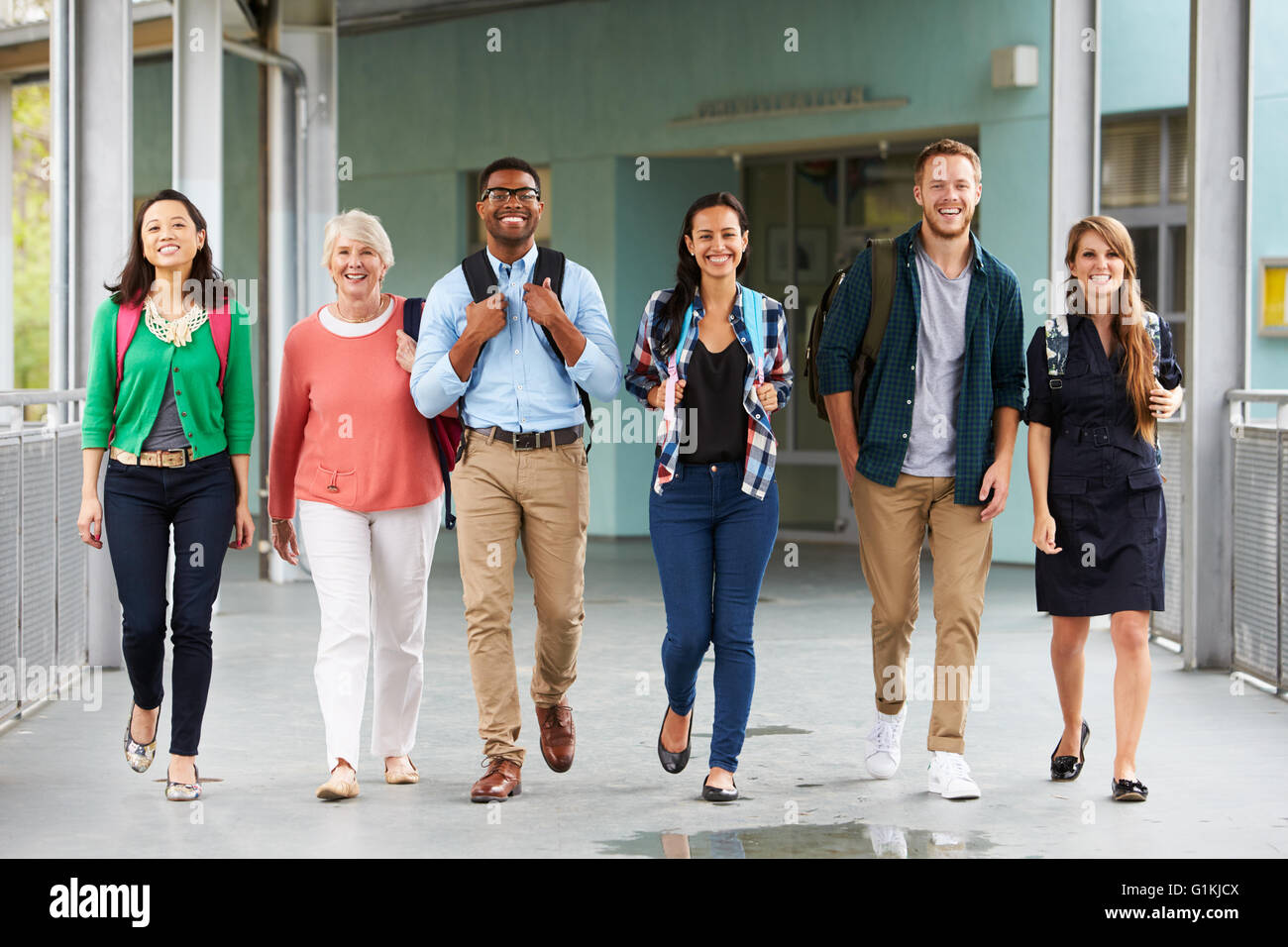 A group of happy teachers walking in a school corridor Stock Photo - Alamy