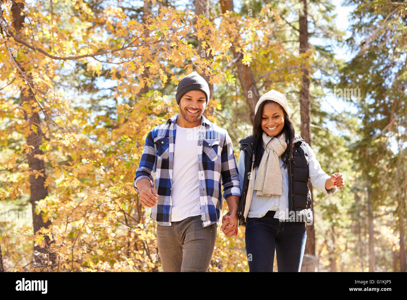 African American Couple Walking Through Fall Woodland Stock Photo - Alamy