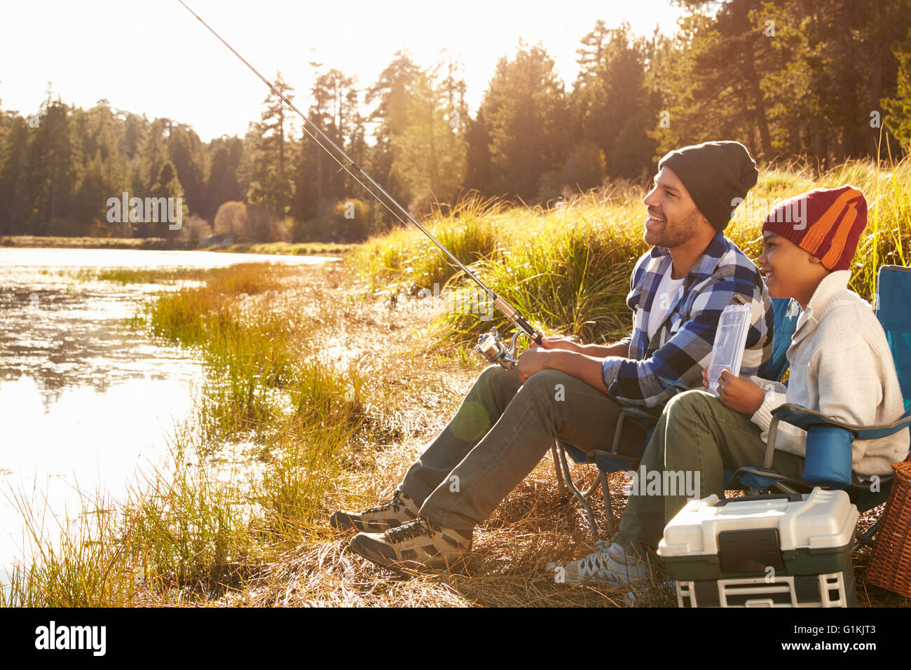 Father Teaching Son To Fish By Lake Stock Photo - Alamy