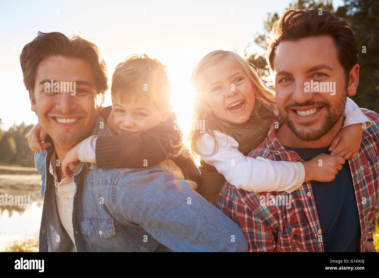 Gay Male Couple With Children Walking By Lake Stock Photo Alamy