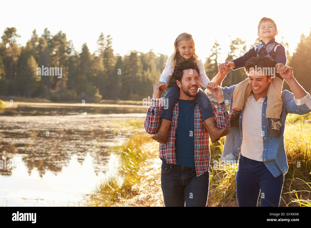 Gay Male Couple With Children Walking By Lake Stock Photo Alamy