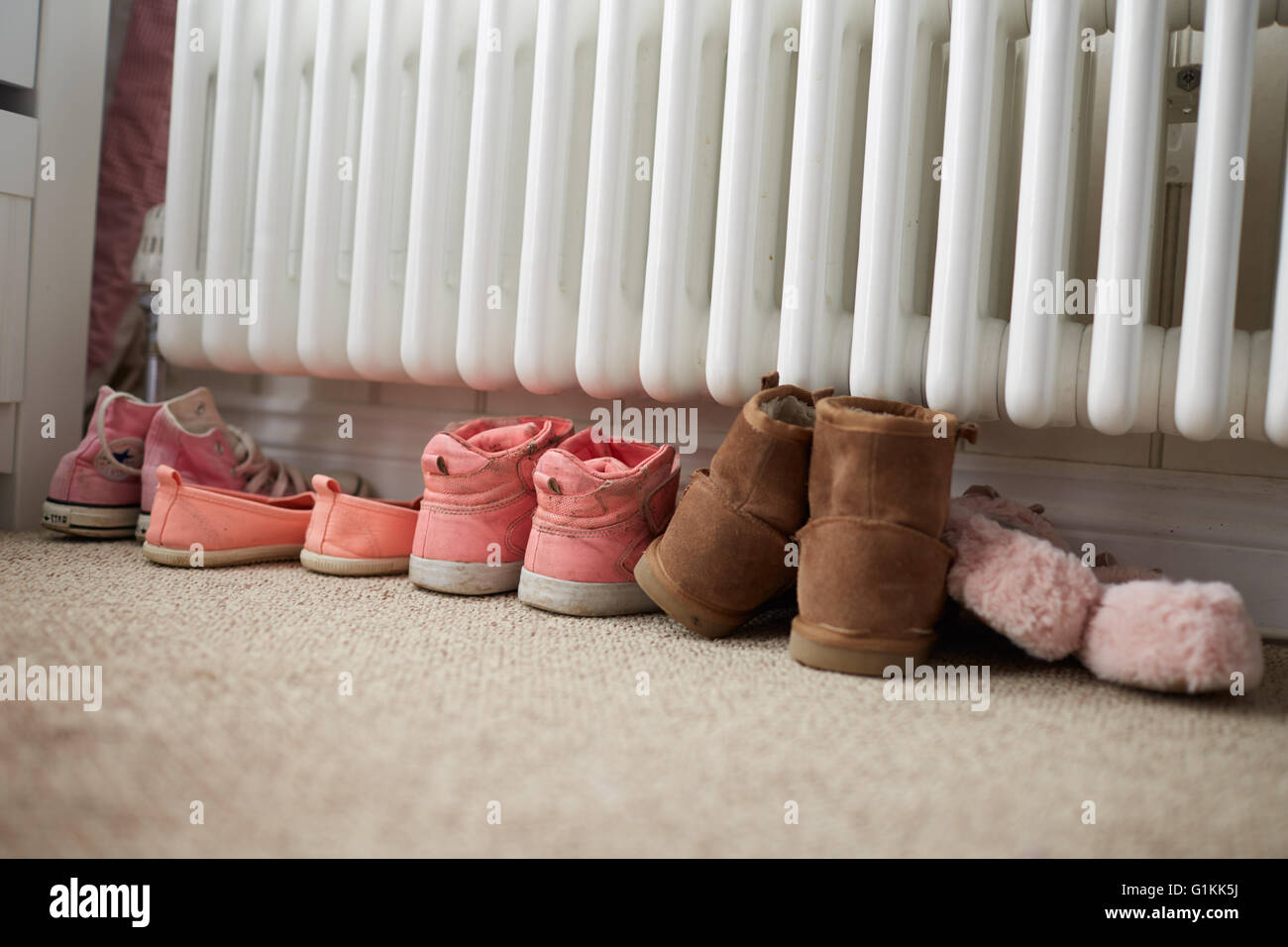 Shoes By Radiator In Family Home Stock Photo