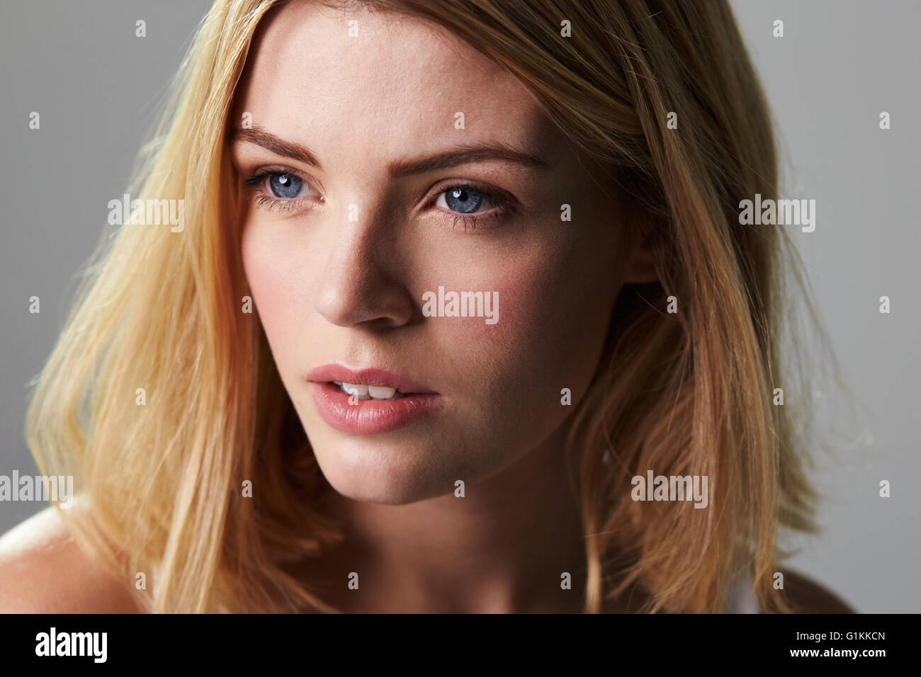 Young blonde woman looking away, close up horizontal Stock Photo
