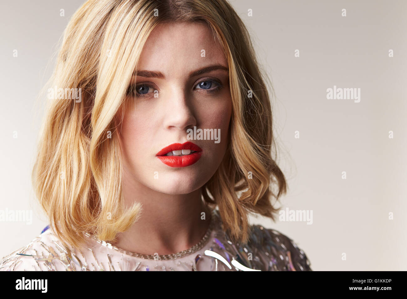 Glamorous blonde woman looks to camera, horizontal portrait Stock Photo
