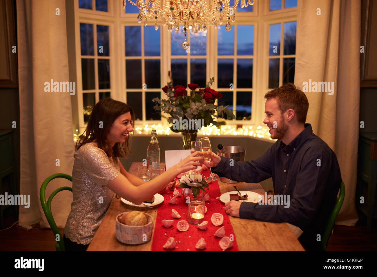 Romantic Couple Make A Toast At Valentines Day Meal Stock Photo