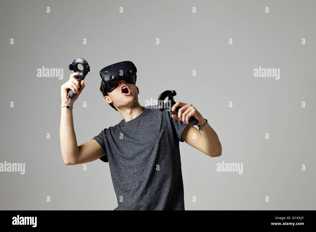 Woman Watching Television Wearing Virtual Reality Headset Stock Photo