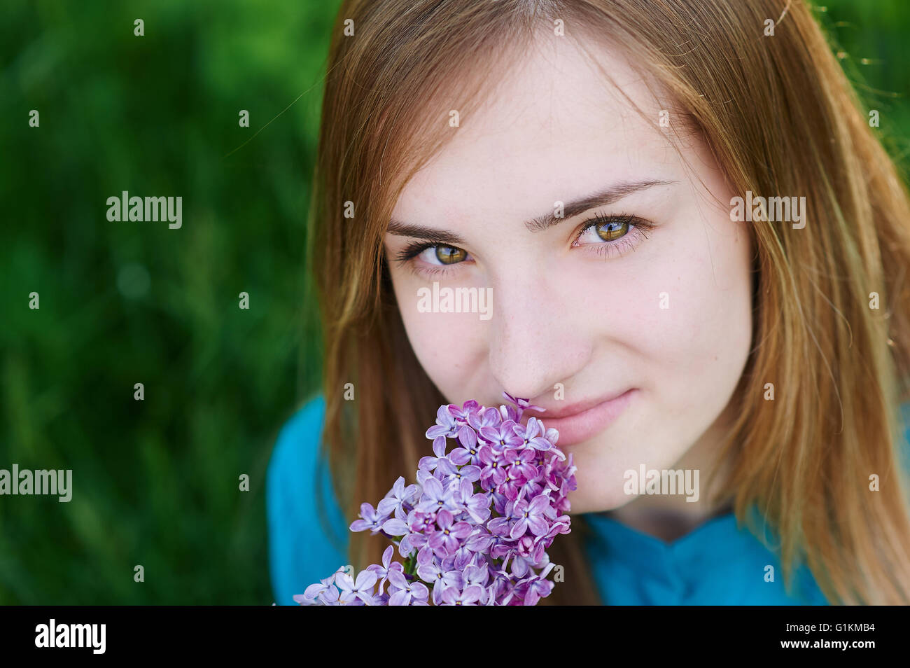 Beautiful woman with flowers of lilac in the hands Stock Photo