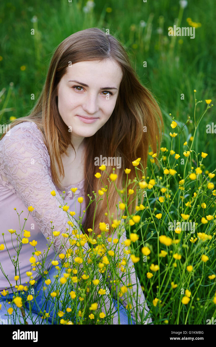 young woman picking flowers on a summer meadow Stock Photo