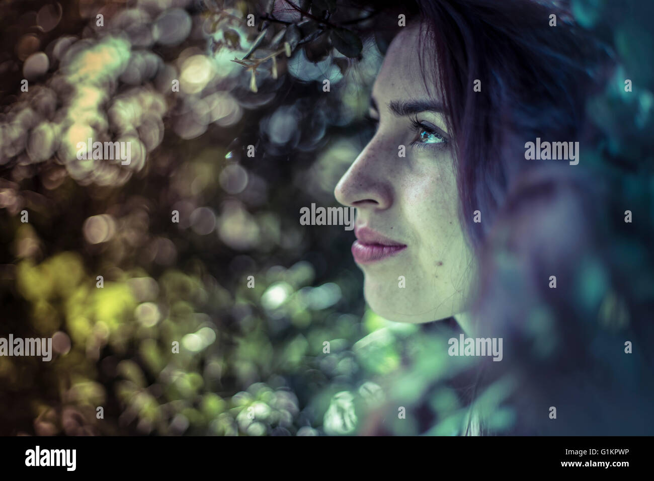 Remember, melancholy young girl in a forest with sad gesture Stock