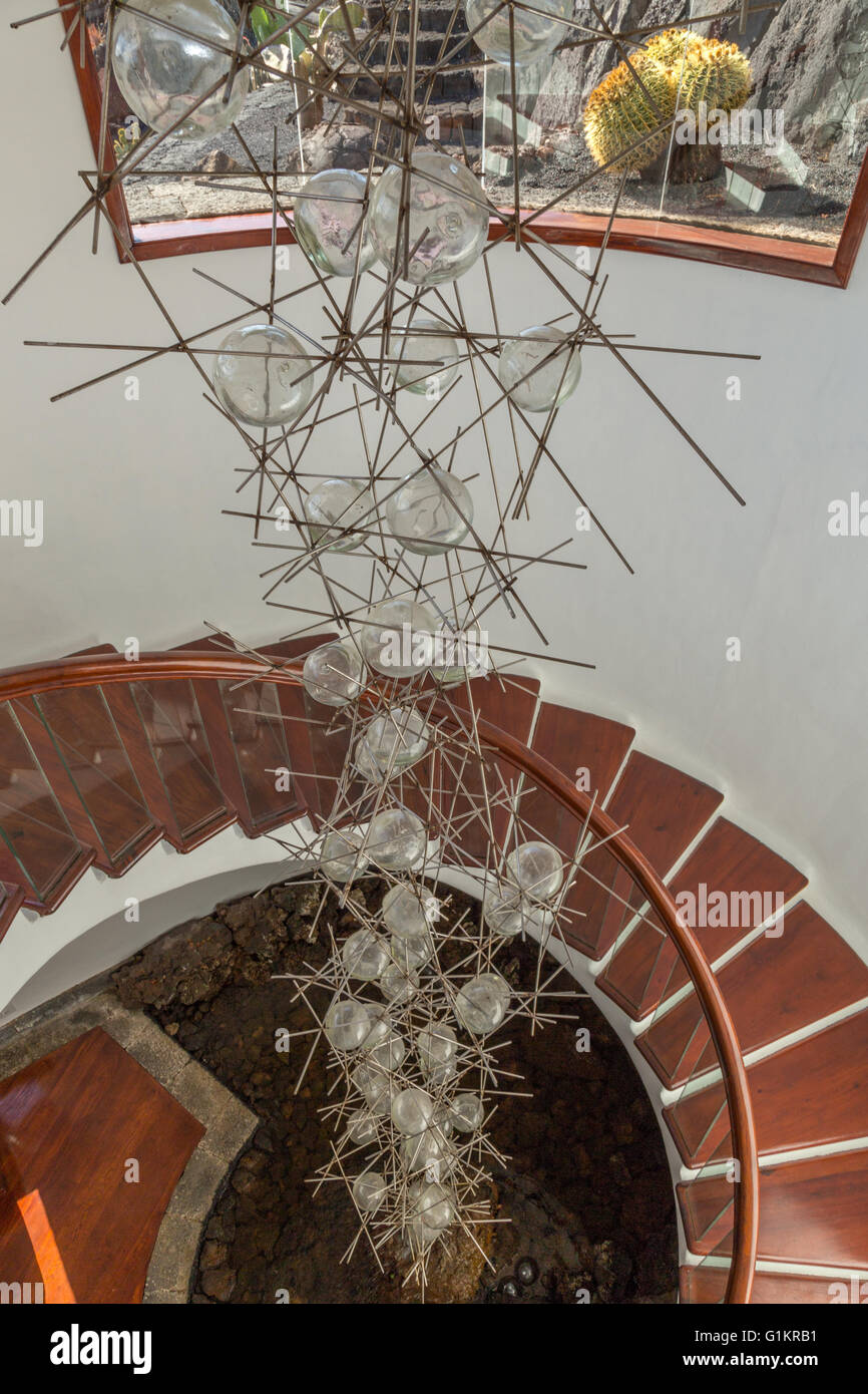 Glass and metal chandelier / artwork inside a helical staircase at the Lanzarote Cactus Garden. Designed by César Manrique. Stock Photo