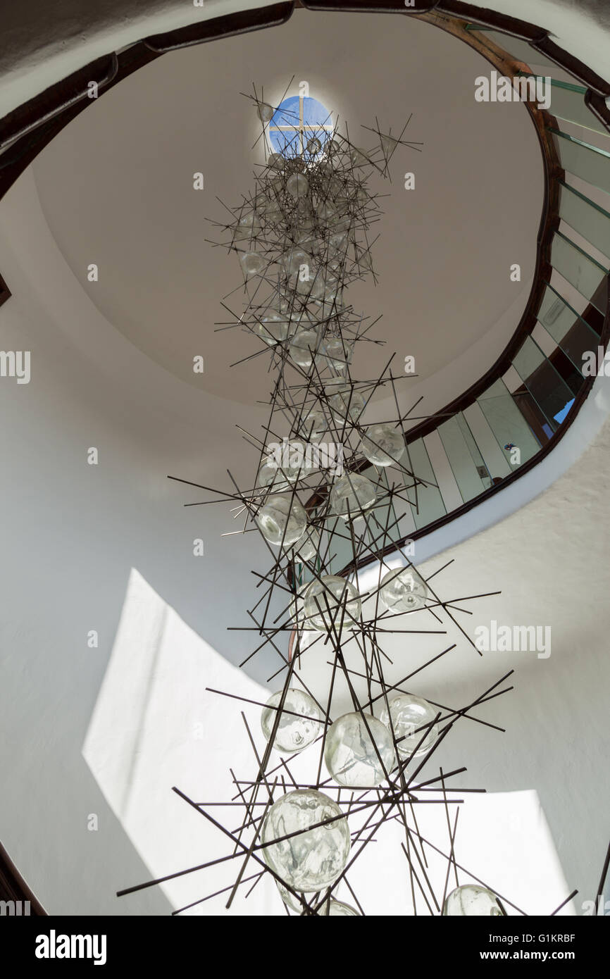 Glass and metal chandelier / artwork inside a helical staircase at the Lanzarote Cactus Garden. Designed by César Manrique. Stock Photo