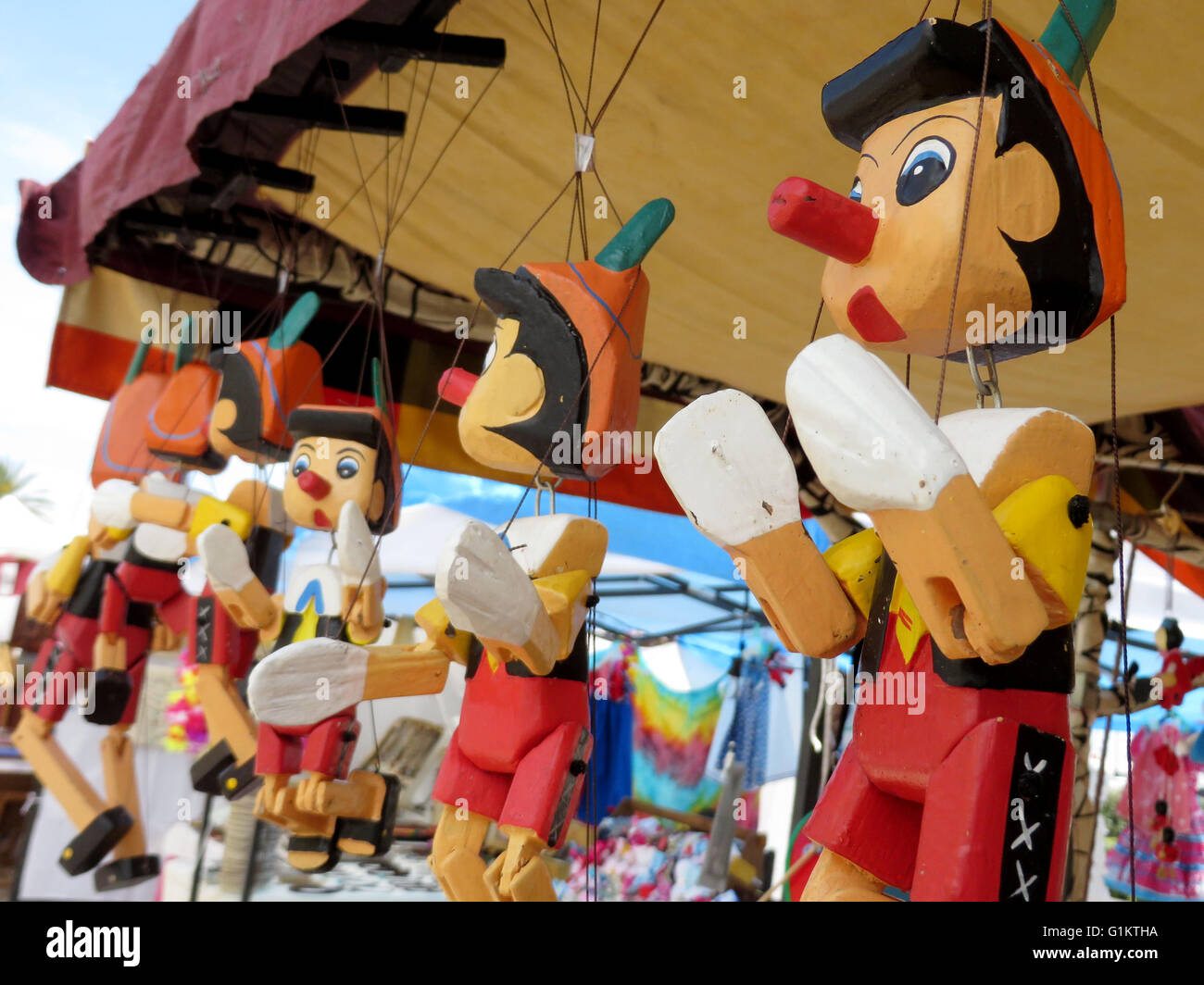 street market Marbella selling Pinocchio puppets, Spain Stock Photo