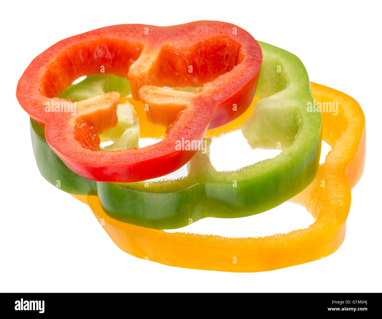 red, green and yellow pepper slices isolated on the white background. Stock Photo