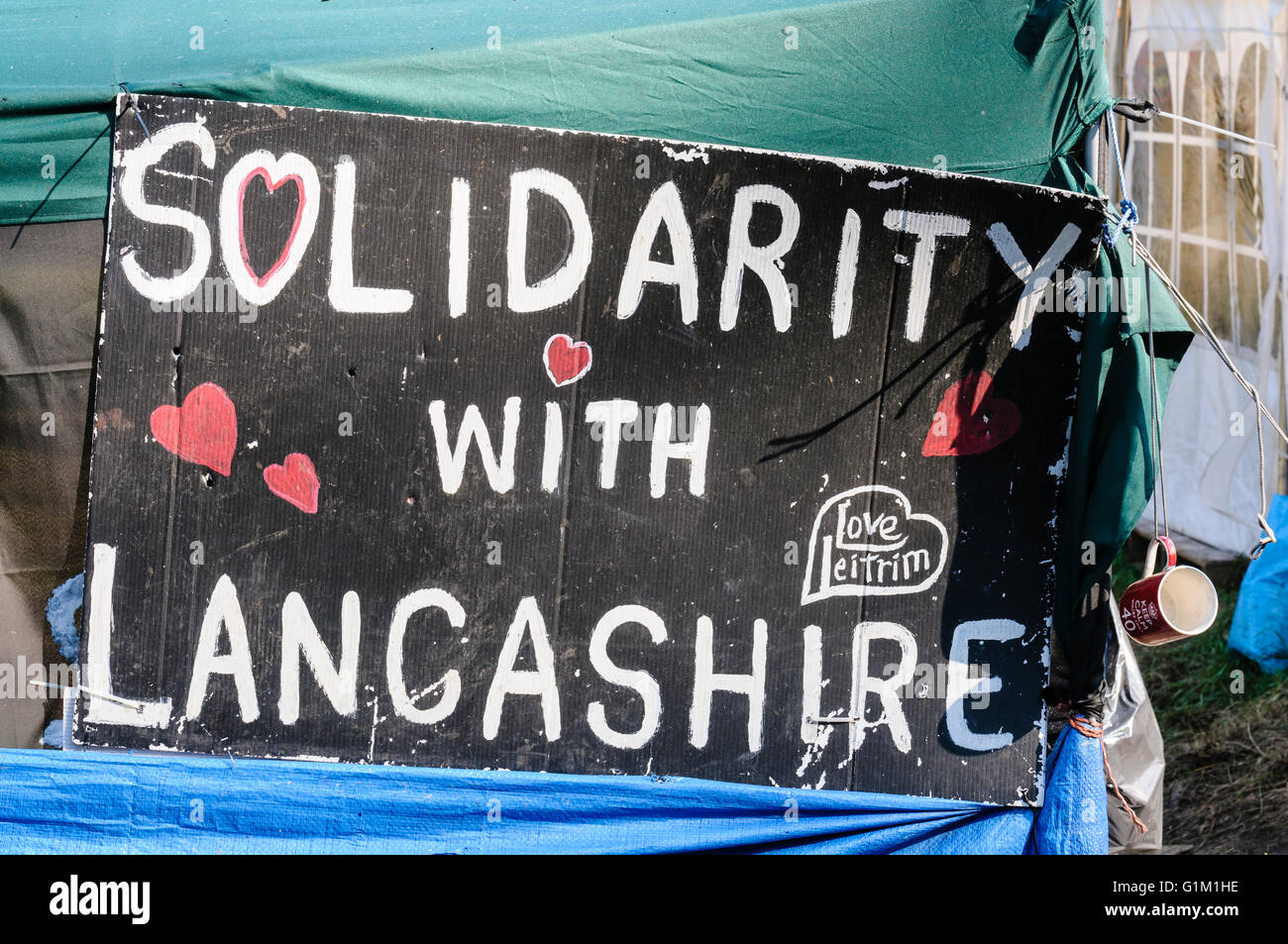Sign saying 'Solidarity with Lancashire' at the protest site in Woodburn Forest, Carrickfergus, where oil drilling is happening Stock Photo
