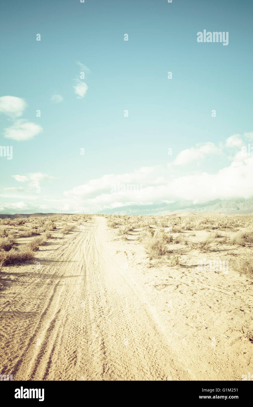 Dirt road in the high desert of California with blue skies. Stock Photo