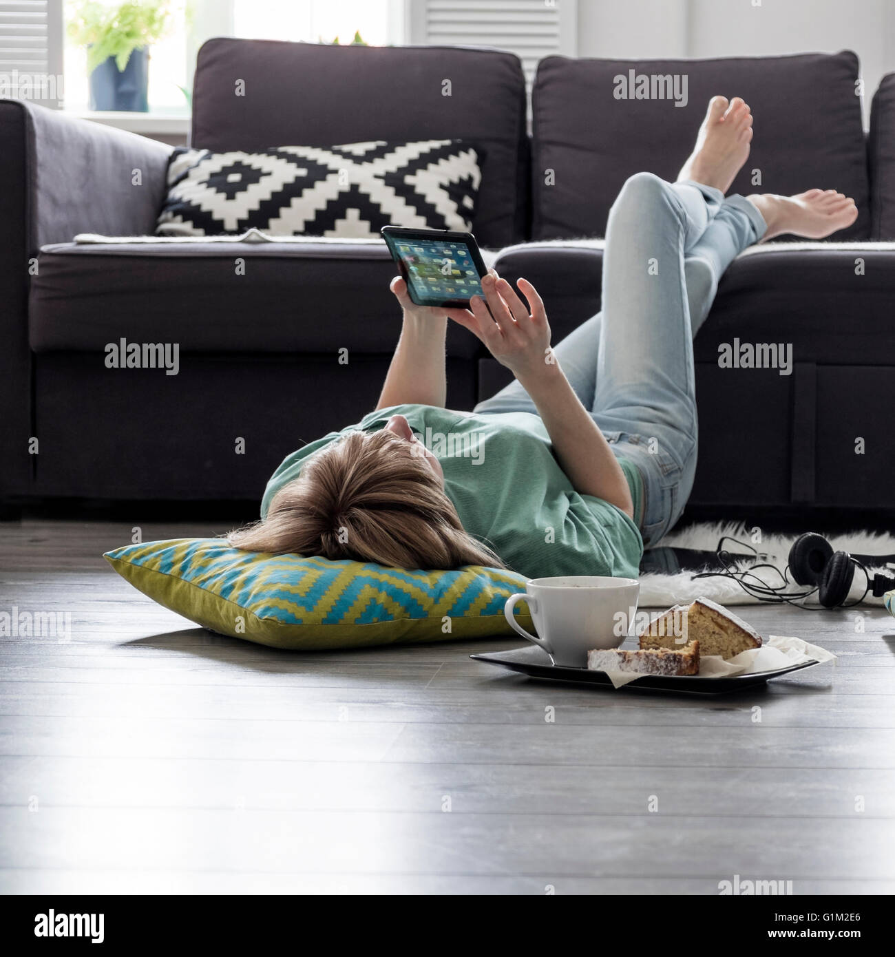 Caucasian woman using digital tablet on floor Stock Photo - Alamy