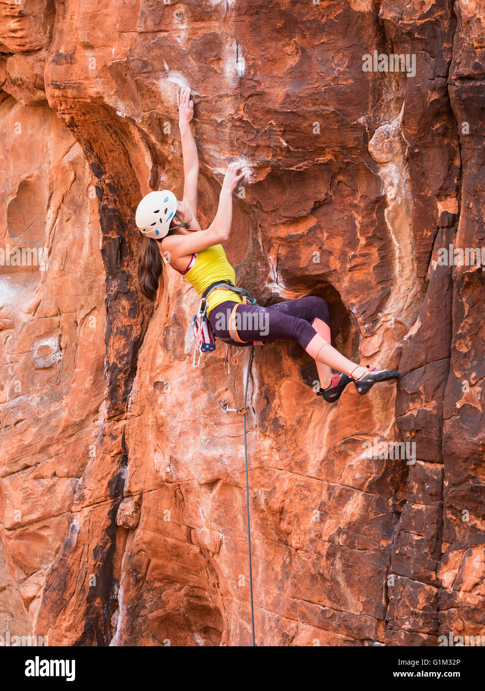 Mixed race girl rock climbing on cliff Stock Photo Alamy