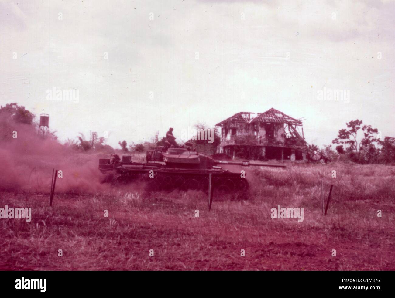 Australian Centurion Tank Passes  ruins of French Colonial House Phuoc Tuy Province South Vietnam 1970 Stock Photo