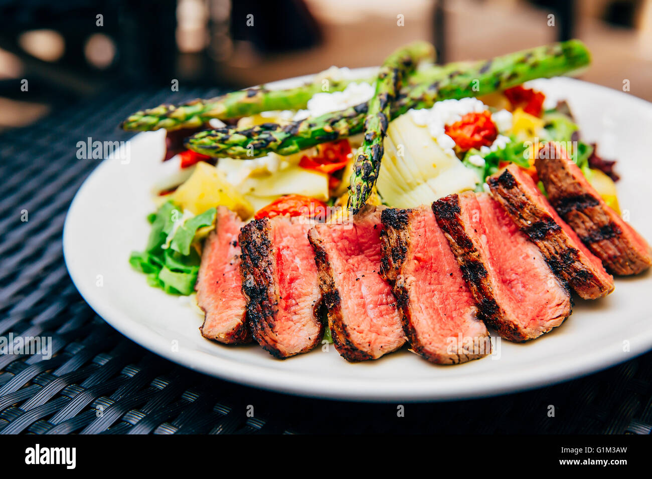 Plate of grilled meat and asparagus salad Stock Photo
