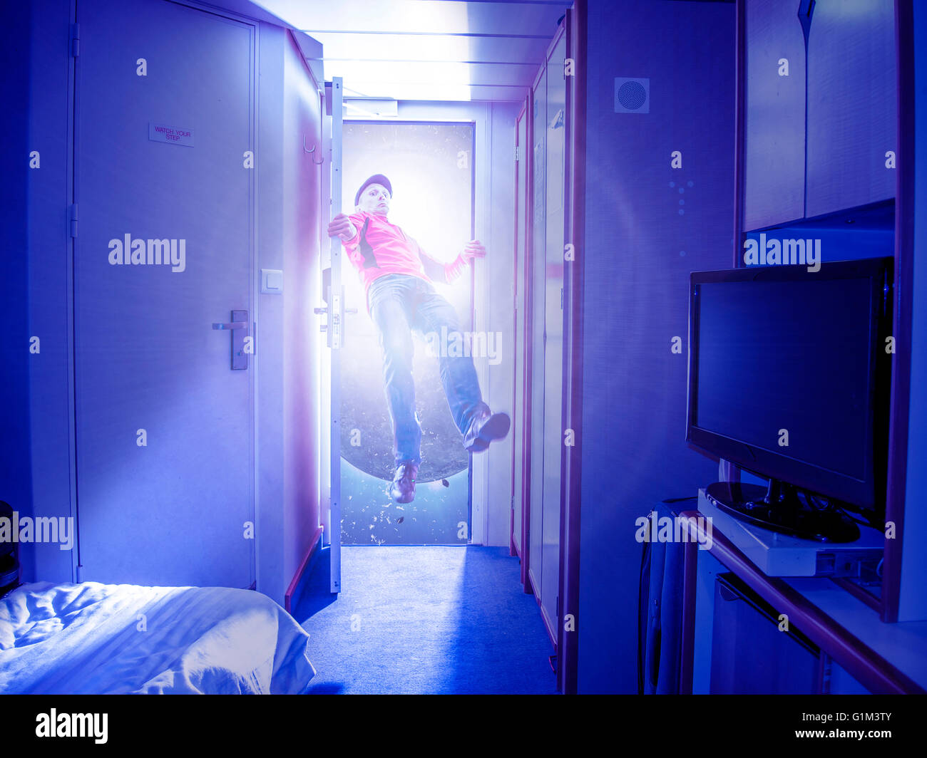 Caucasian man flying in bedroom Stock Photo