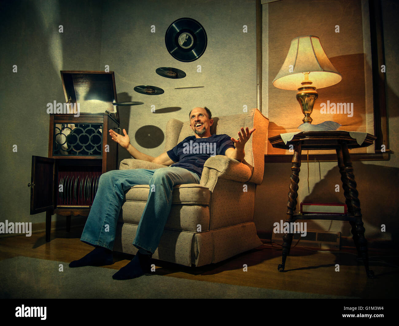 Caucasian man levitating records in living room Stock Photo