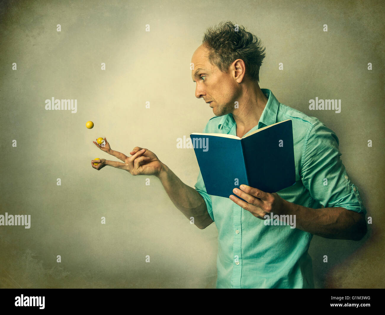 Caucasian man juggling fruit with finger hands Stock Photo