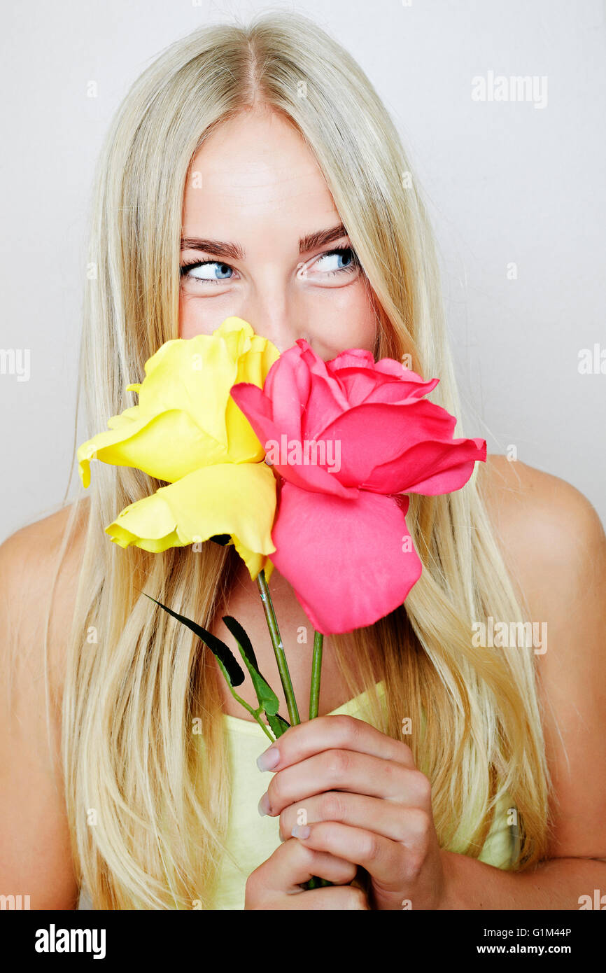 Caucasian woman smelling flowers Stock Photo Alamy