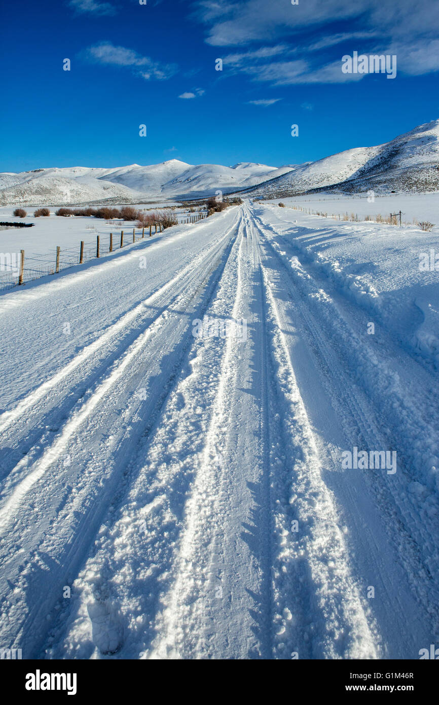 Tire tracks on snowy remote road Stock Photo - Alamy