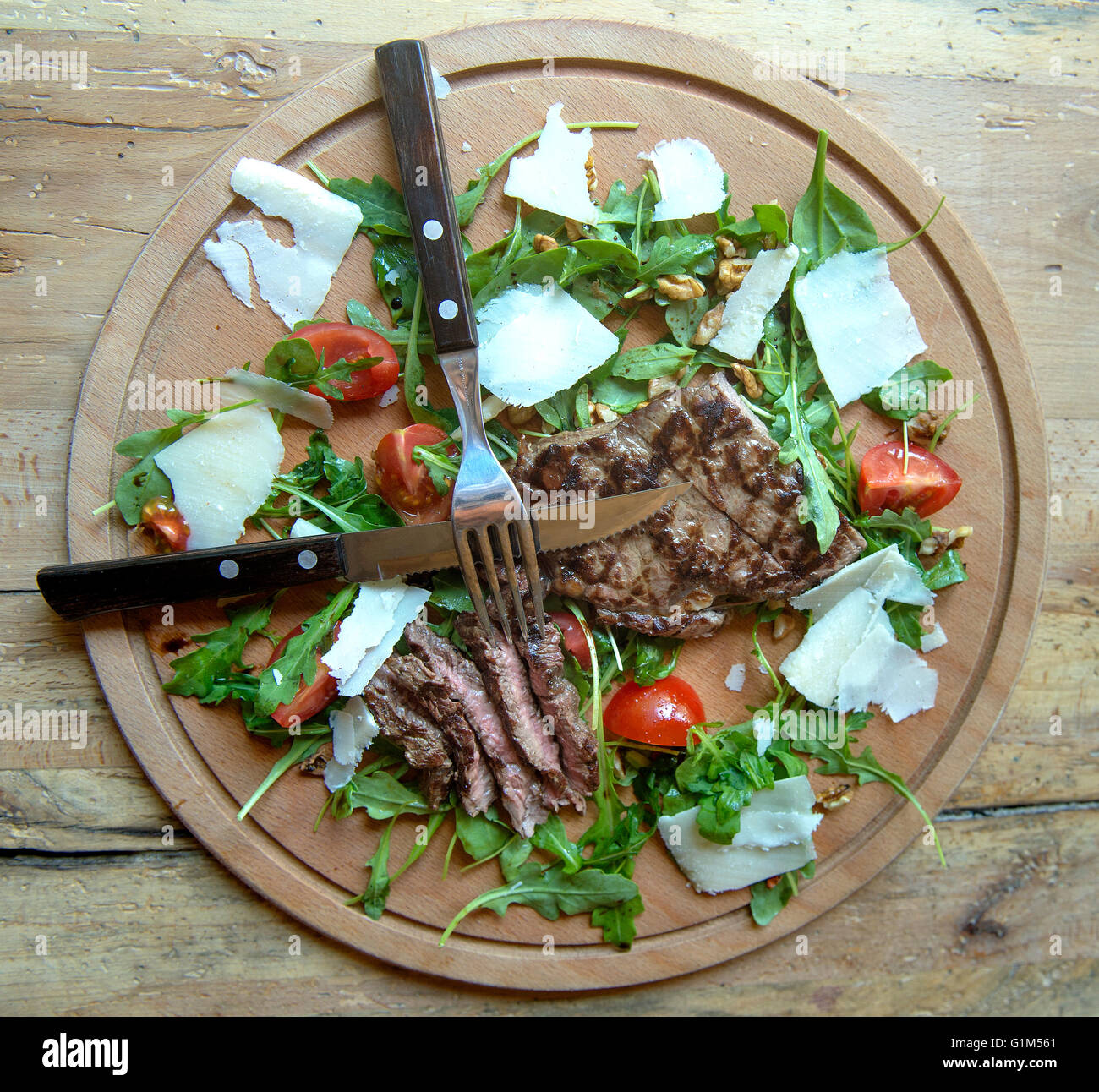 Brazilian beef steak with arugula, parmesan and cherry tomatoes Stock