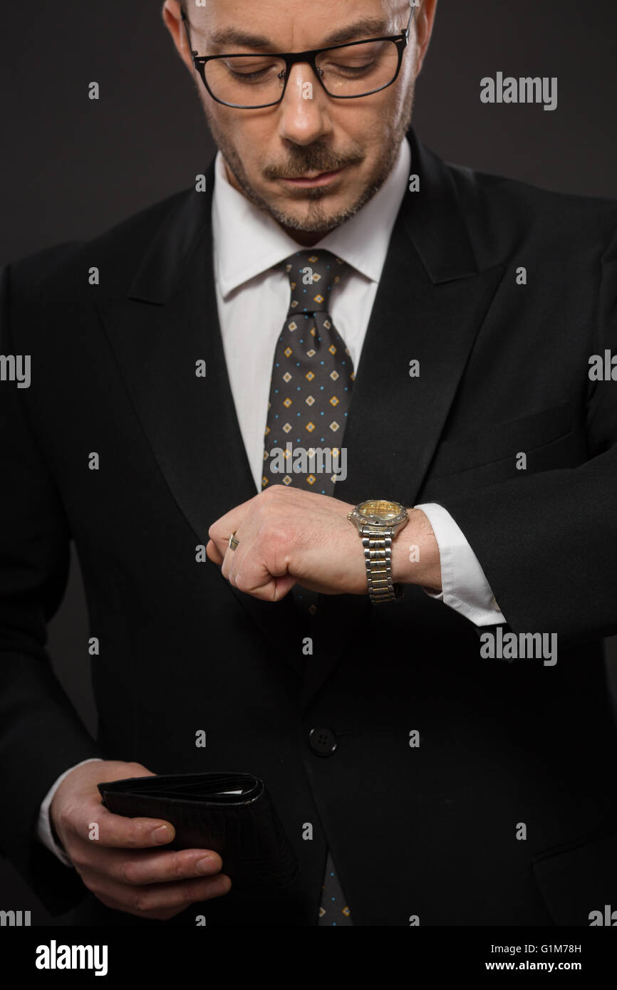 Businessman checking time Stock Photo - Alamy