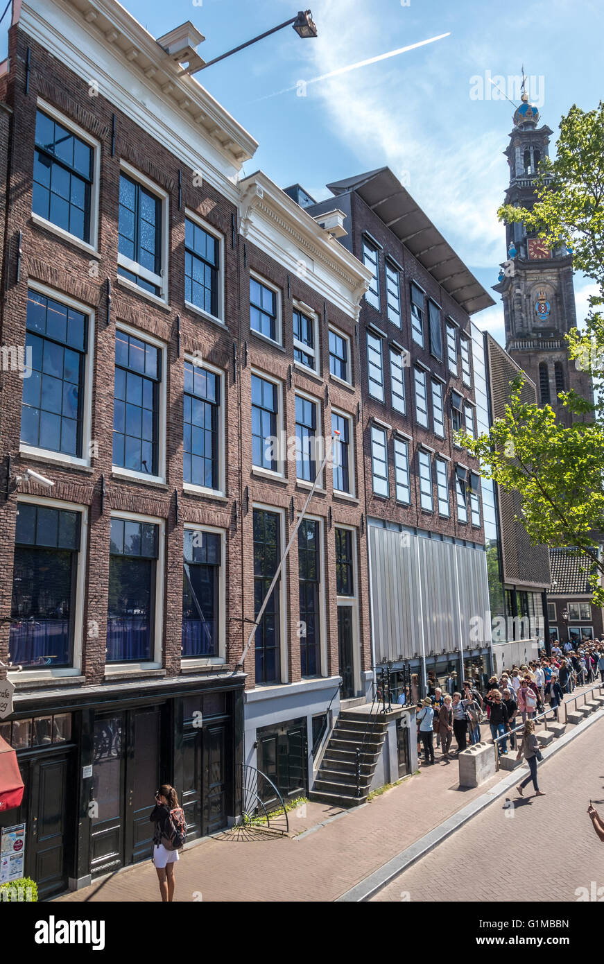 Anne Frank house and Anne Frank museum and entrance with tourists in lines. Amsterdam Prinsengracht Canal in Spring. Stock Photo