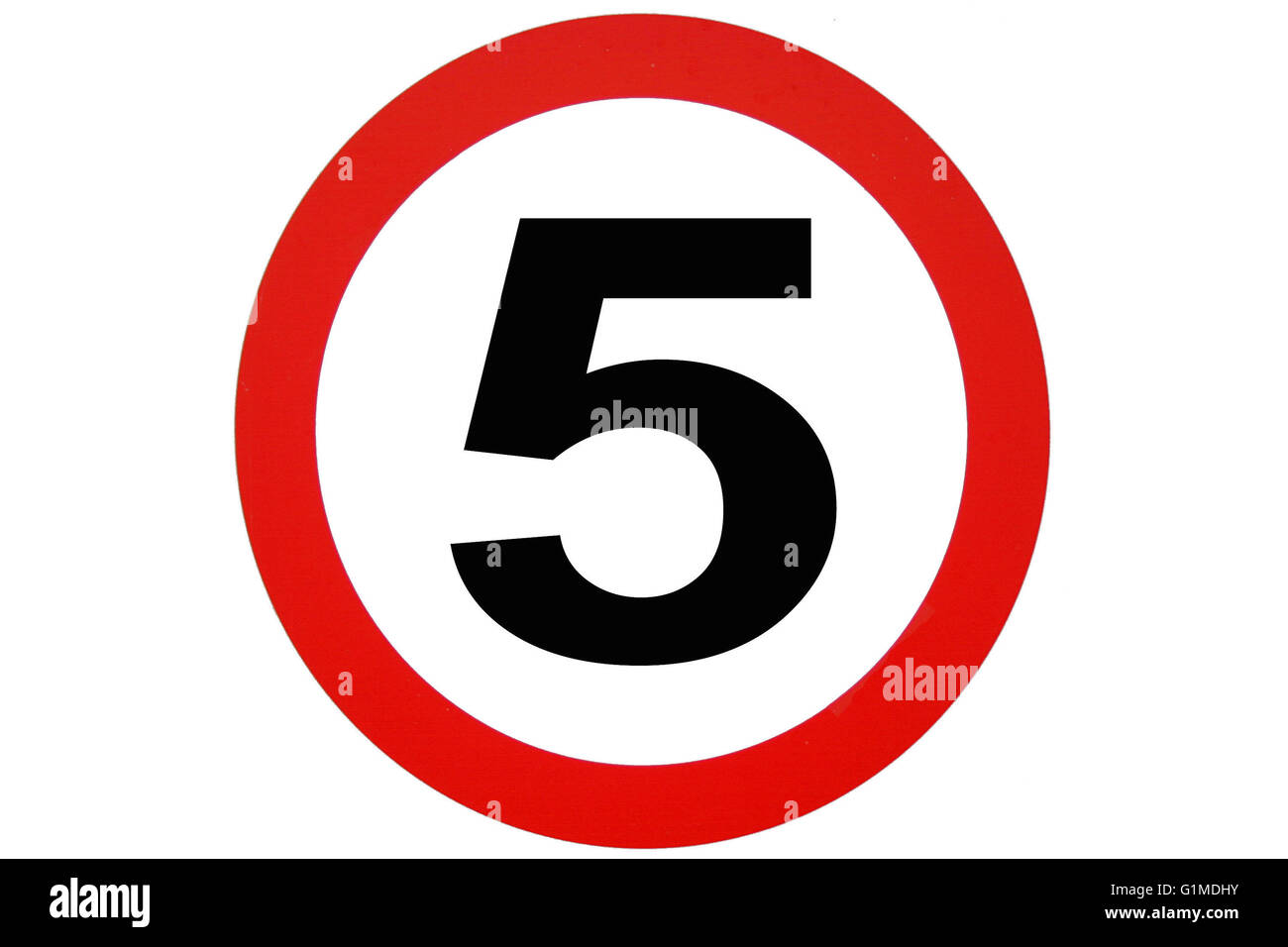 A red white and black circular speed limit road sign with the number five in black in the center, depicting five miles or kilometers an hour maximum . Stock Photo