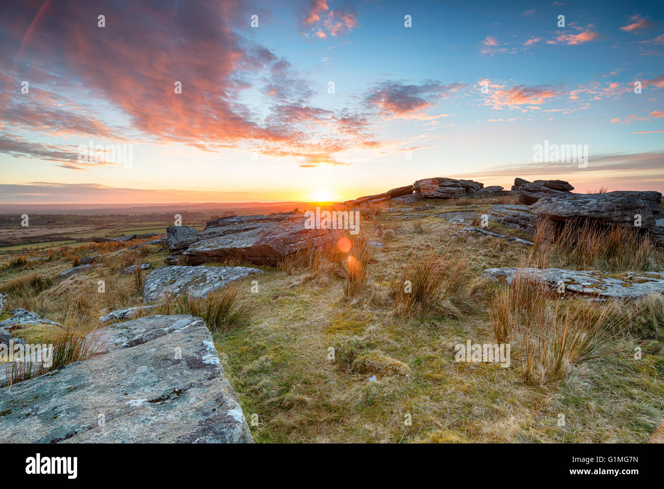 Stunning sunset over slabs of granite rocks at the top of Alex Tor near