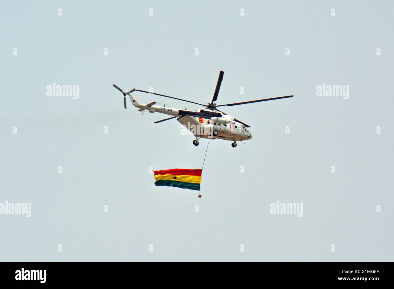 Ghana Air Force Helicopter, with attached Ghana Flag, overflying Accra