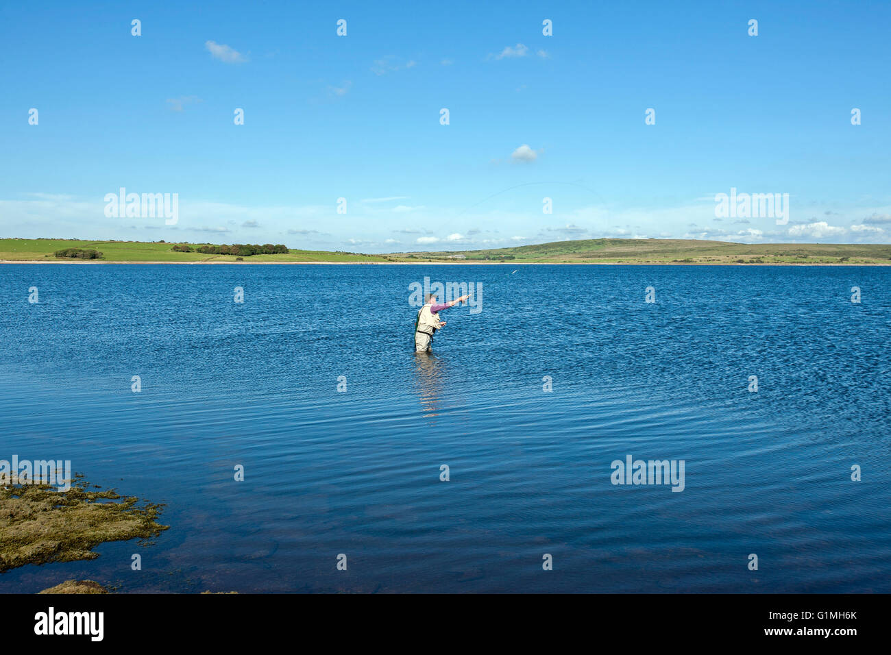fly fishing on Colliford reservoir lake Bodmin Moor Cornwall lone man