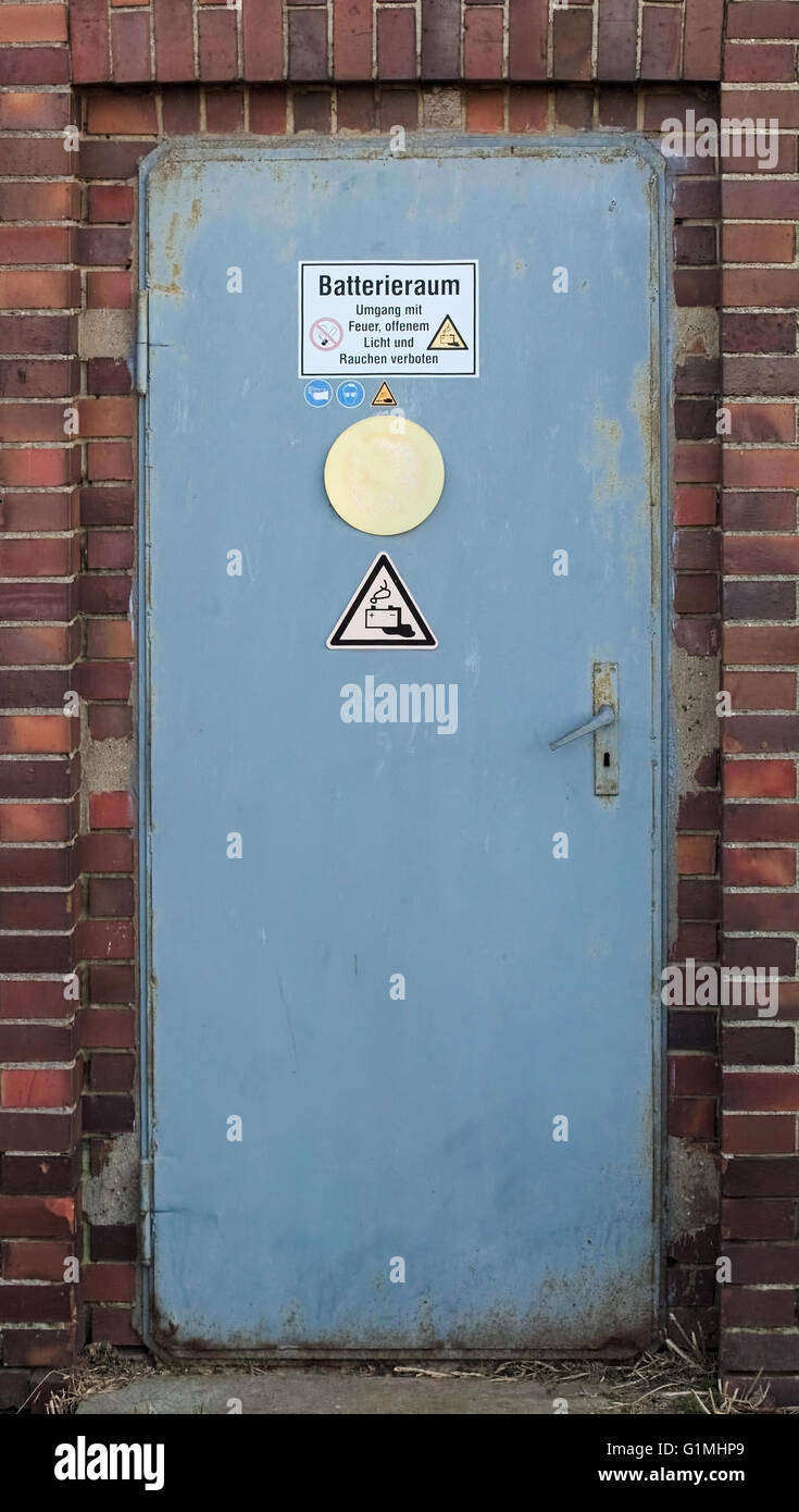 Battery room with with warning sign and various symbols. The text means