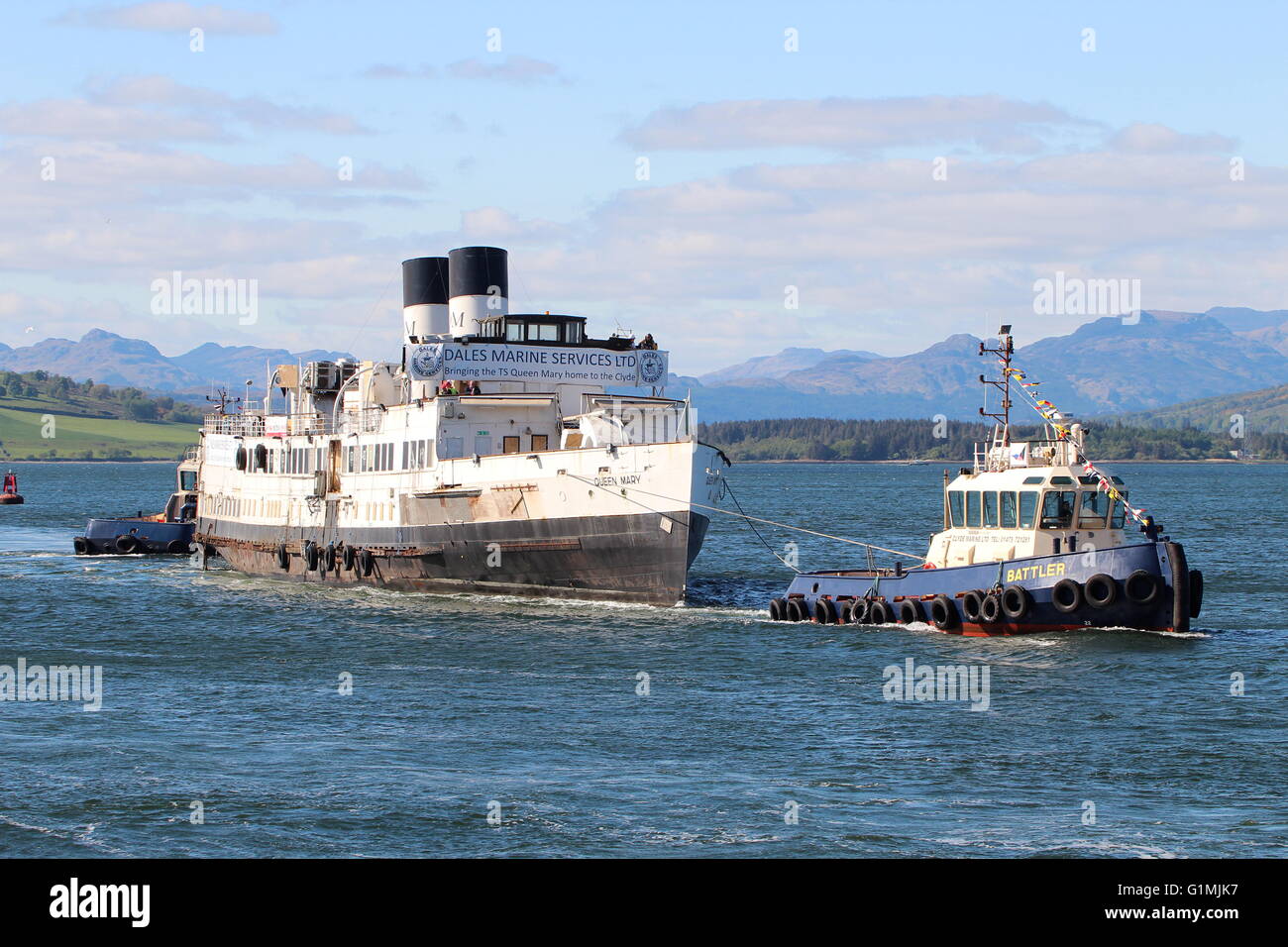 The arrival of the historic steamer the TS Queen Mary back to the Clyde, with the tugs Battler and Bruiser in attendance. Stock Photo