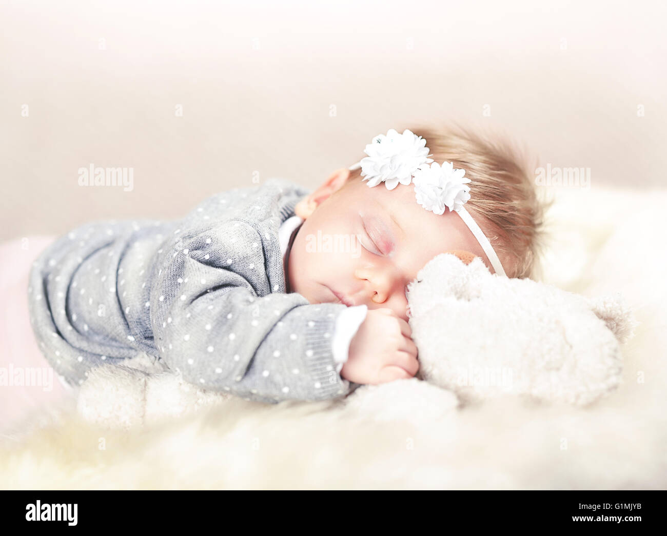 sleeping femal baby on classic white fur Stock Photo