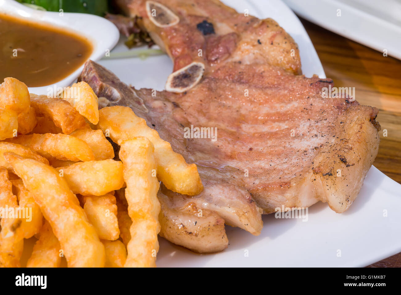 French Fries And Steak Pork Chop With Mushroom Mustard Sauce Stock Photo Alamy