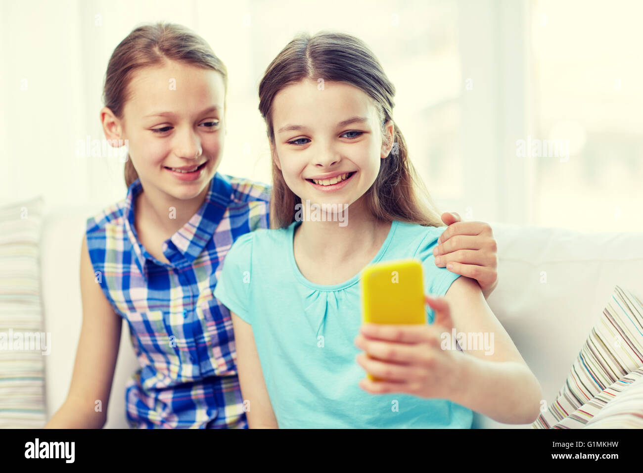 happy girls with smartphone taking selfie at home Stock Photo - Alamy