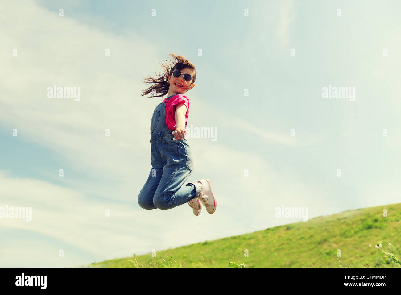 happy little girl jumping high outdoors Stock Photo - Alamy