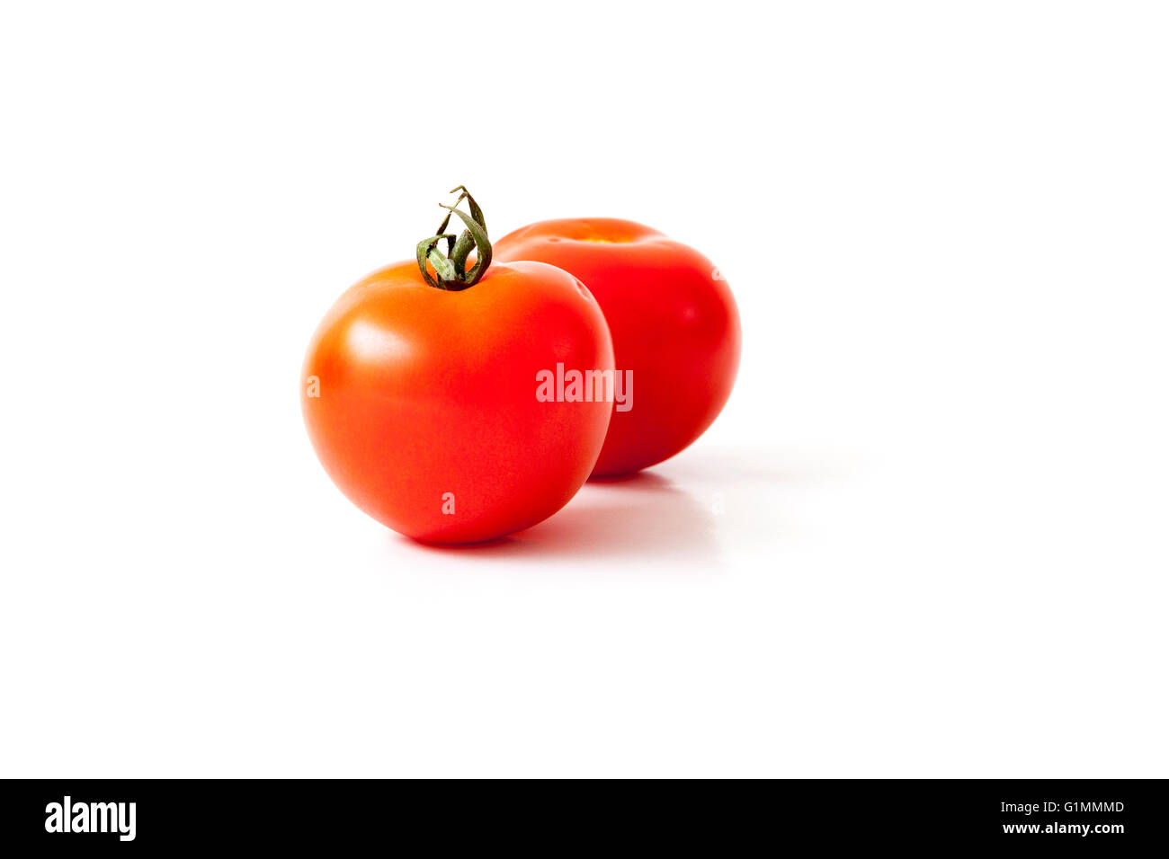 Two red tomatoes isolated on a white background Stock Photo