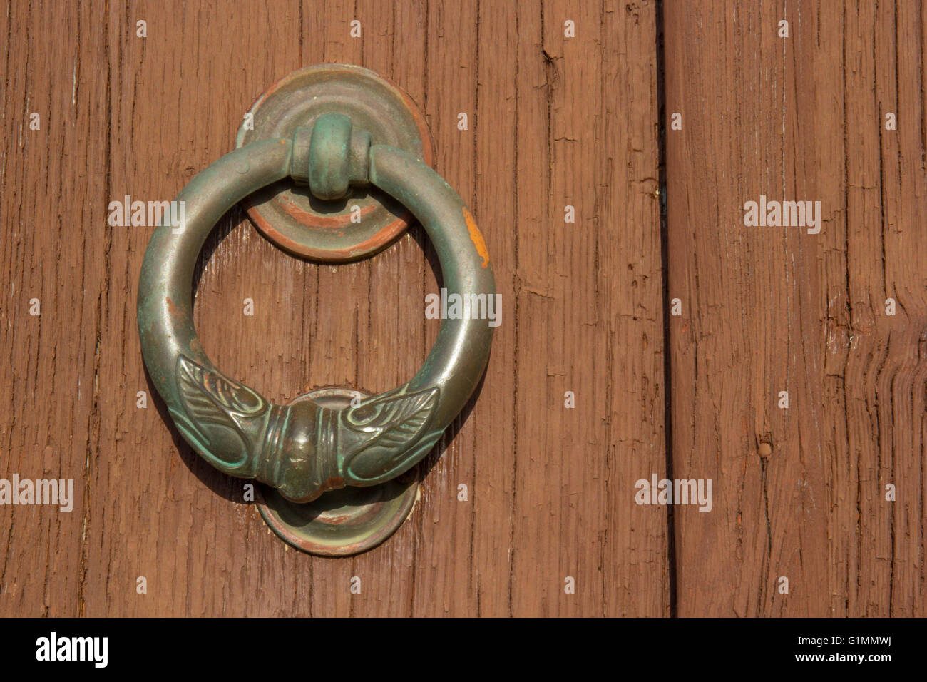 Knocker brass ring of old wooden door Stock Photo