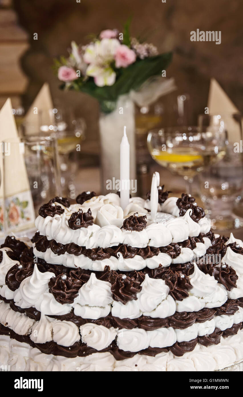 Big birthday chocolate and foam cake on the table. Symbolic food ...