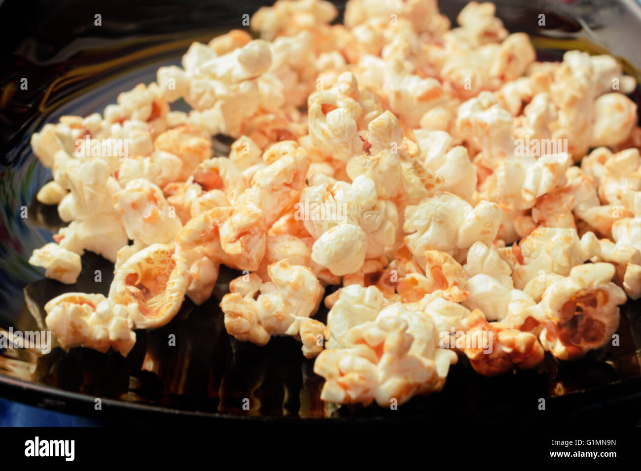 Fresh popcorn on black plate for party Stock Photo