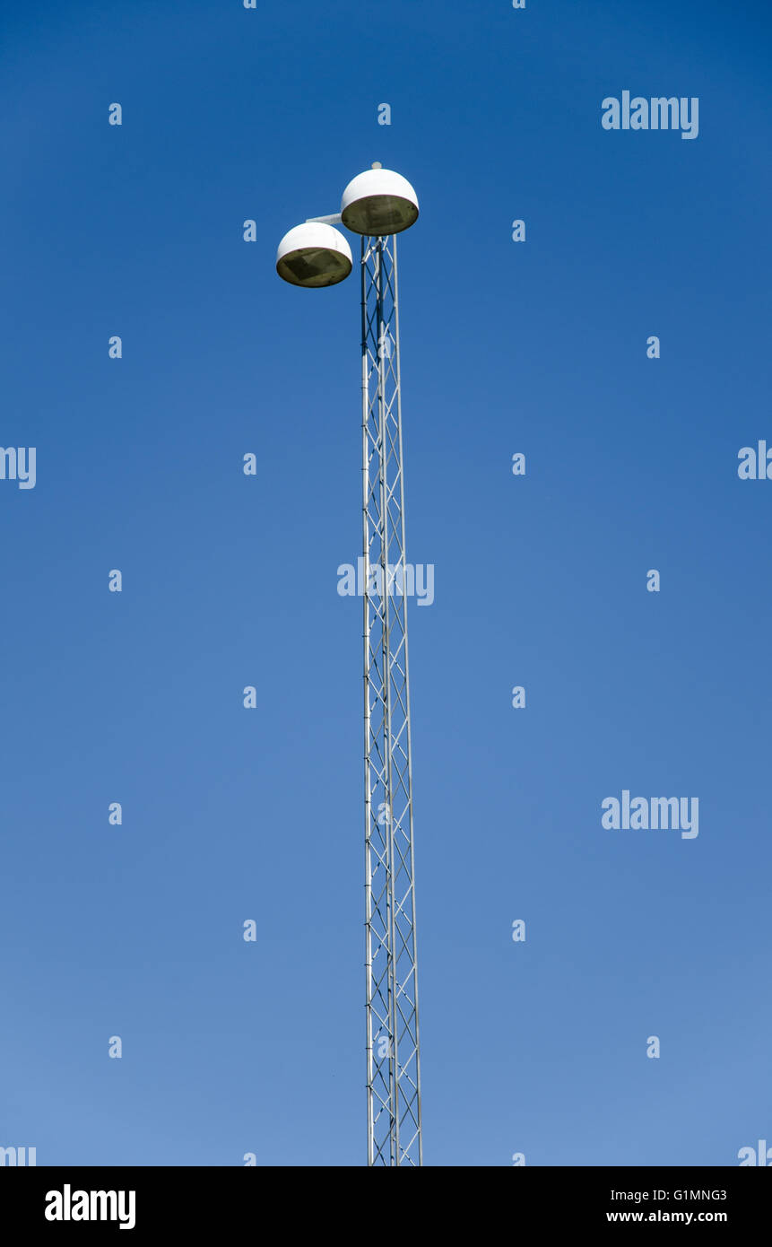 Road lighting post with double bulbs with a background of blue sky Stock Photo