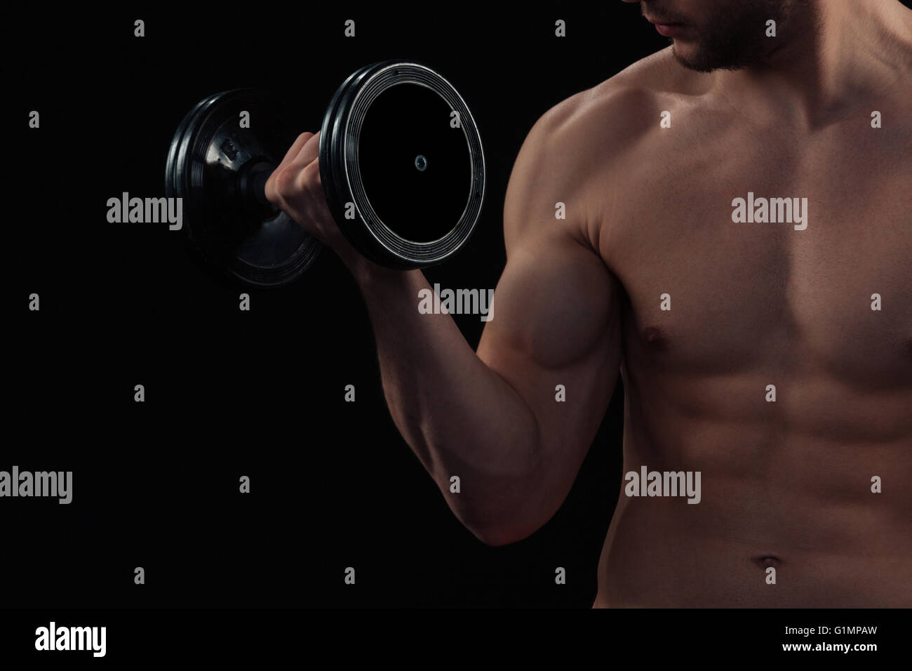 Cropped image of a muscular man workout with dumbbell Stock Photo