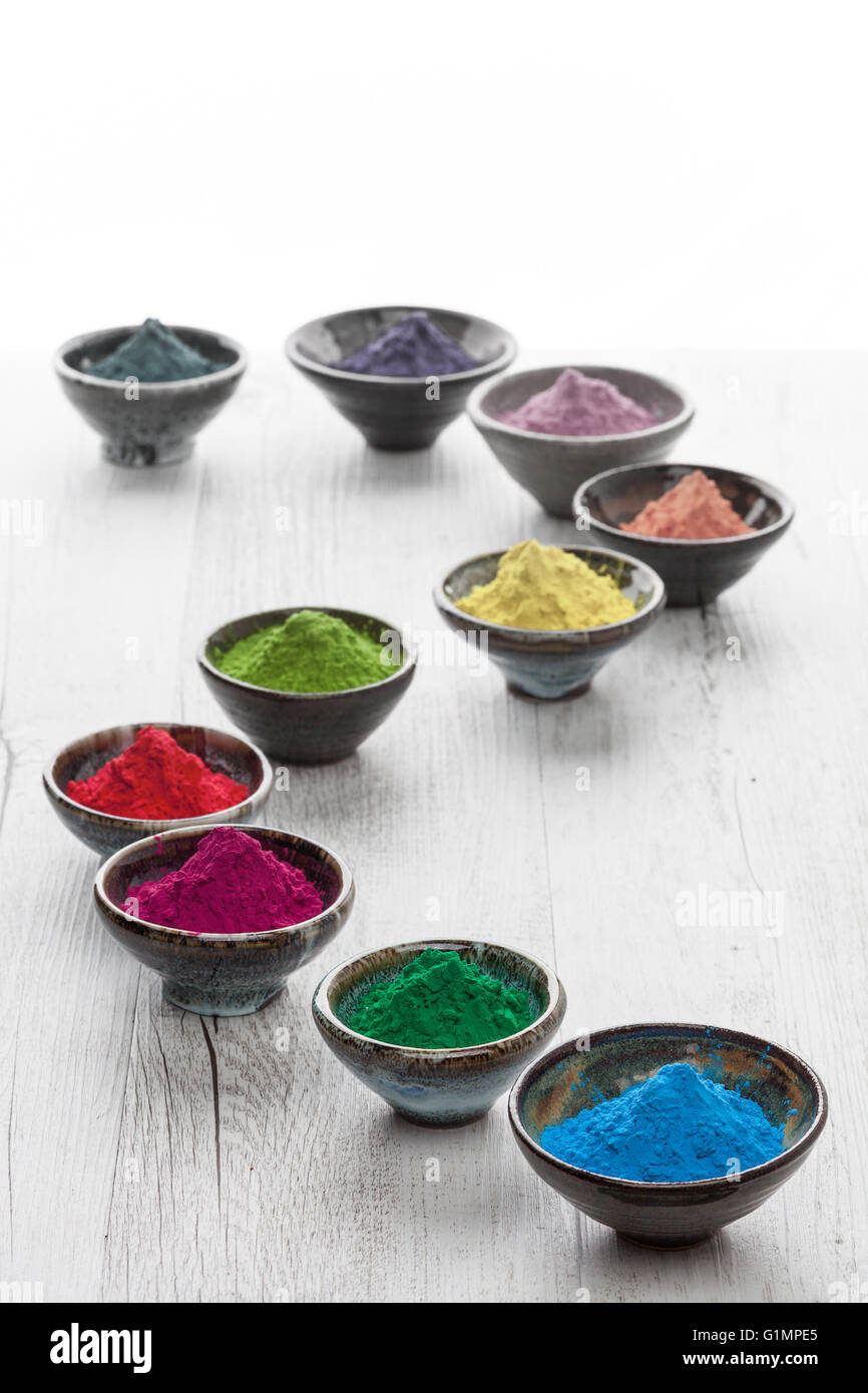 Colorful Holi powder in containers over white background Stock Photo - Alamy