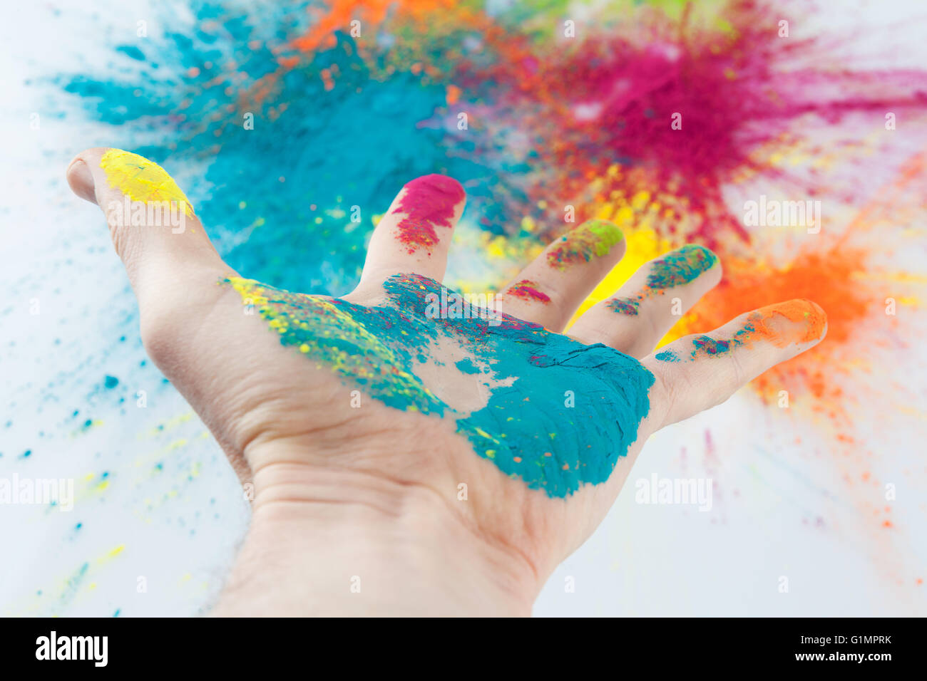 Open hand painted with Holi powder with blurred colorful background Stock  Photo - Alamy